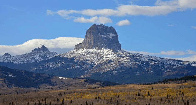 Chief Mountain rising above autumn foothills